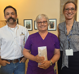 Drs. Bret McNabb and Jane Sykes present Stacy Zindel (center) with her award.