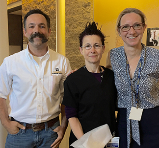 Drs. Bret McNabb and Jane Sykes present Michele Santoro (center) with her award.