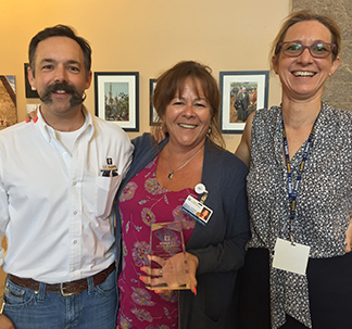 Drs. Bret McNabb and Jane Sykes present Theresa Varland (center) with her award.