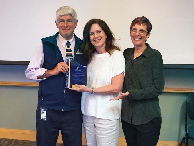 Amy Zeifang (middle), daughter of David and Cheryl Duffield, accepted the El Blanco Award on their behalf from Dean Mark Stetter and Koret Shelter Medicine Program Director Kate Hurley.